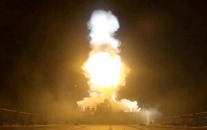Smoke billows after military strikes during escalating US-Iran tensions near the Strait of Hormuz.