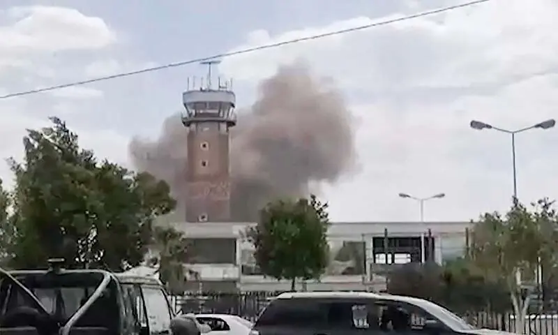 Yemen Conflict with smoke rising after an airstrike at Sanaa International Airport