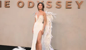 Zendaya poses in a winged white Matières Fécales gown at The Odyssey premiere in New York.