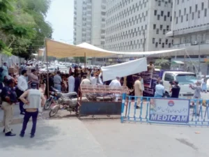 Members of the Contractors Association of Sindh stage a protest outside the Karachi Press Club against alleged unfair distribution of development funds.