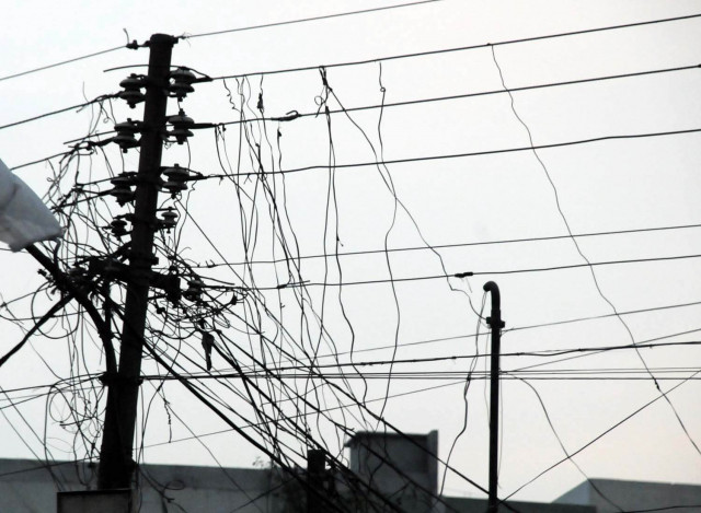 Employees work during a power outage at a Sindh education office in Karachi.