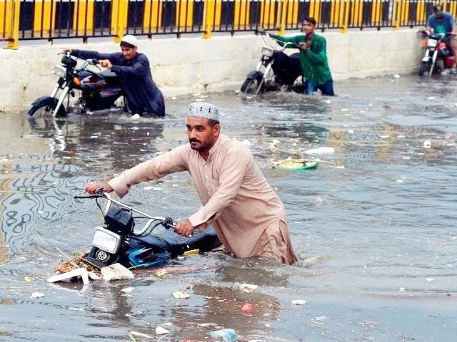 Municipal workers remove debris from a storm-water drain in Karachi as authorities prepare for the monsoon season.