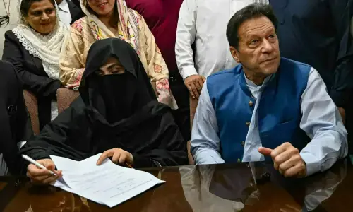 Imran Khan and Bushra Bibi during court proceedings related to the Al-Qadir case.