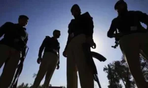 Police personnel inspect the scene of a suspected IED blast targeting a patrol vehicle in Tank district.