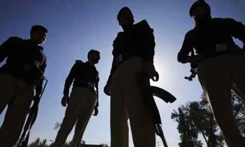 Police personnel inspect the scene of a suspected IED blast targeting a patrol vehicle in Tank district.
