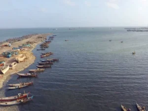 Cargo ships sail through the Strait of Hormuz after Qatar restores full maritime navigation following regional security tensions.