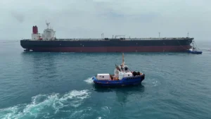 An oil tanker sails through the Strait of Hormuz as global oil prices climb amid rising US-Iran tensions.