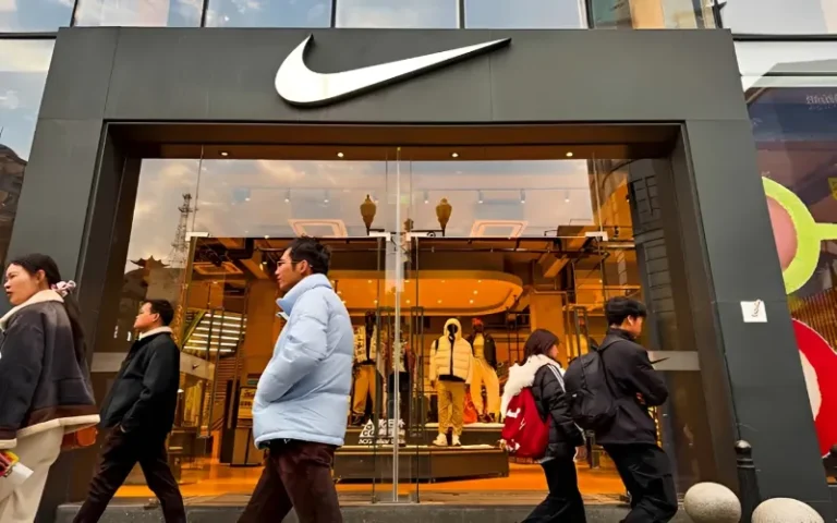 Nike logo displayed at a retail store as the company restructures its online distribution network in China.