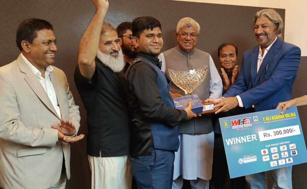 Rana Irfan receives the trophy after winning the Ali Asghar Valika All-Pakistan Snooker Championship in Karachi.