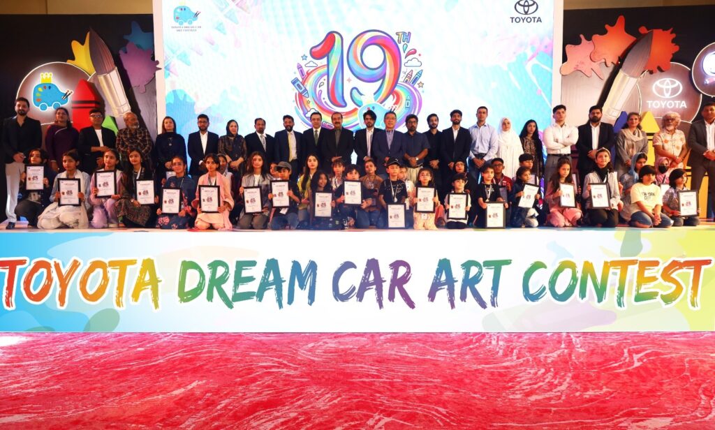 Children and officials pose during the Toyota Dream Car Art Contest awards ceremony organised by Indus Motor Company in Pakistan.