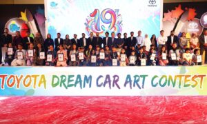Children and officials pose during the Toyota Dream Car Art Contest awards ceremony organised by Indus Motor Company in Pakistan.