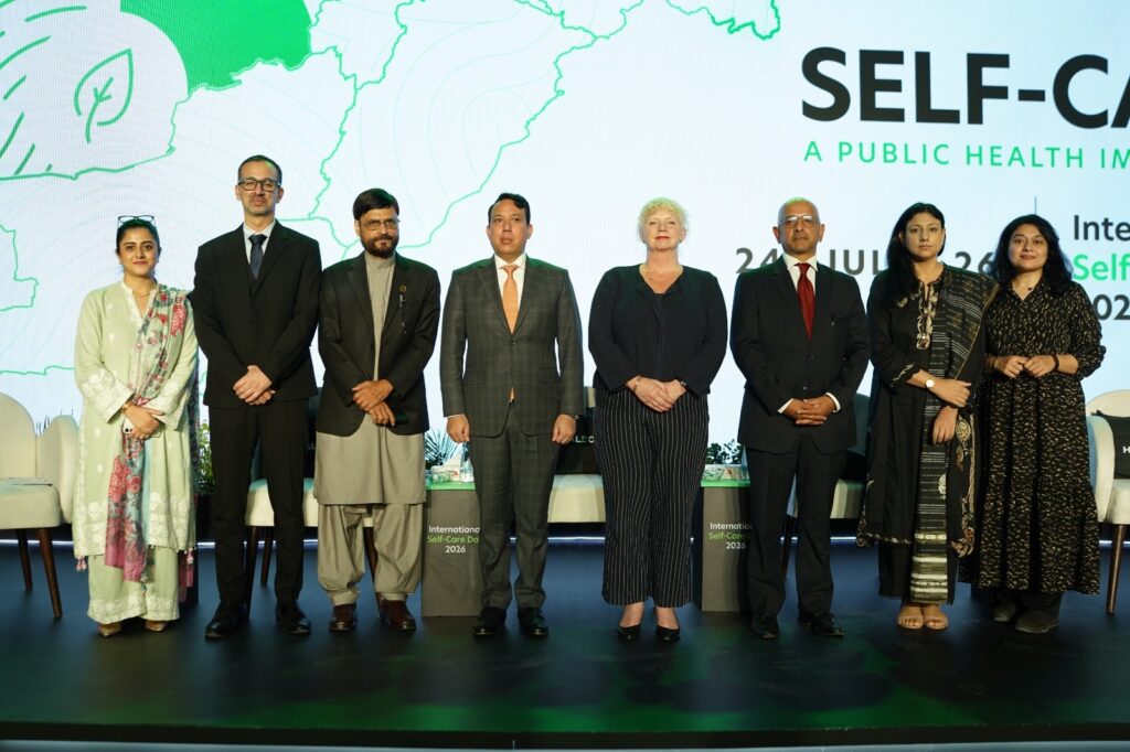Participants at Pakistan's first national dialogue on International Self-Care Day discussing public health and health literacy.