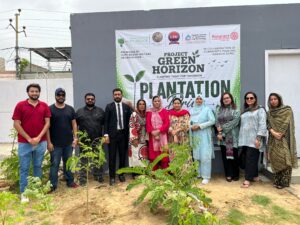 Hope Bridge Welfare Organization members and guests plant trees during the launch of Project Green Horizon in Karachi.