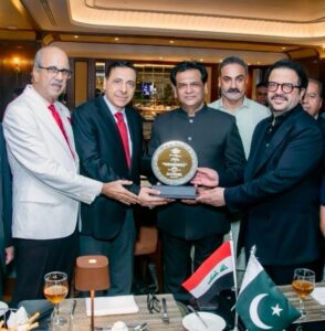 Dr. Maher Mjhid receives a memento of appreciation from architect Kafeel Hussain during a farewell ceremony in Karachi.