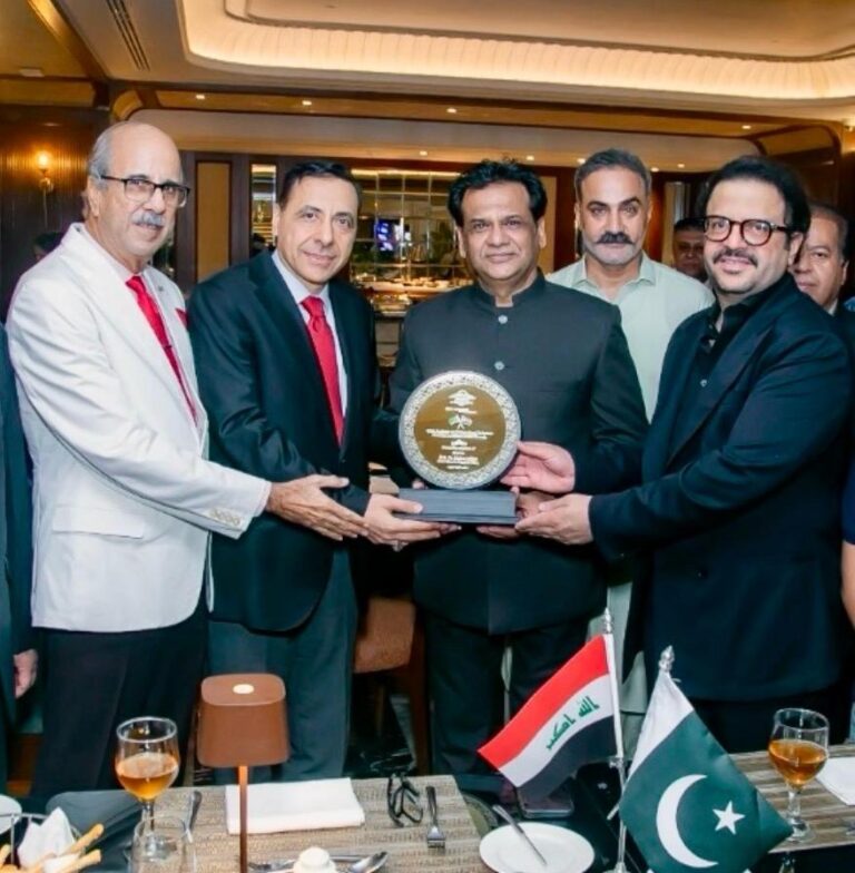 Dr. Maher Mjhid receives a memento of appreciation from architect Kafeel Hussain during a farewell ceremony in Karachi.