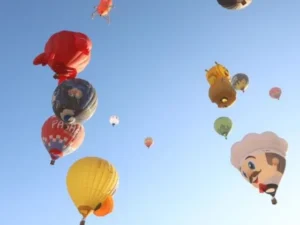 Colourful special-shaped hot air balloons flying above Cappadocia's fairy chimneys during the Cappadocia Balloon Festival.