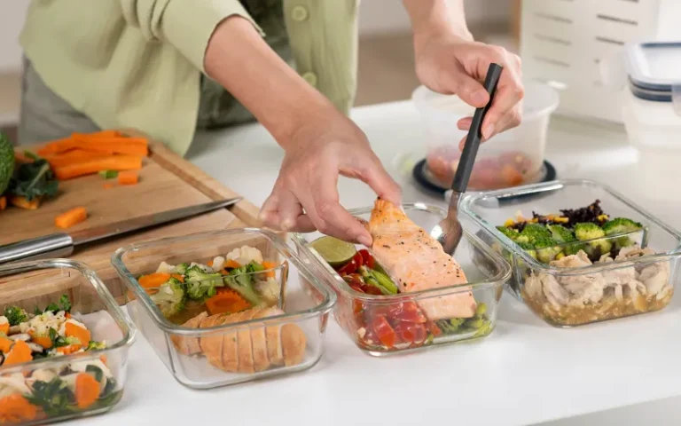 High-protein foods such as eggs, chicken breast, fish, Greek yogurt, beans and pumpkin seeds arranged on a table.