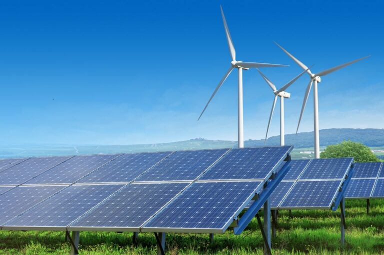 Wind turbines and solar panels at a renewable energy project approved by NEPRA near Karachi.