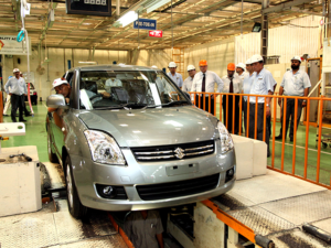 Electric and hybrid vehicles displayed at an automobile showroom during Pakistan's auto policy debate