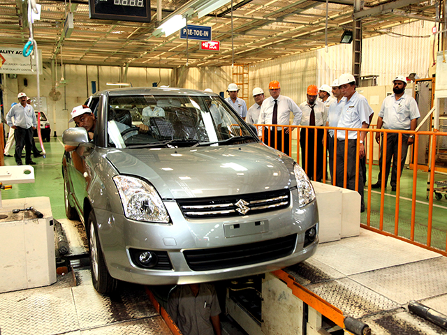Electric and hybrid vehicles displayed at an automobile showroom during Pakistan's auto policy debate