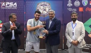 Egypt's Salman Khalil receives the winner's trophy after defeating Nasir Iqbal in the Pakistan Navy Fleet Club Open International Squash Championship.