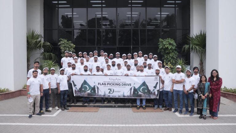 IMC employees collecting national flags during a Karachi volunteer drive