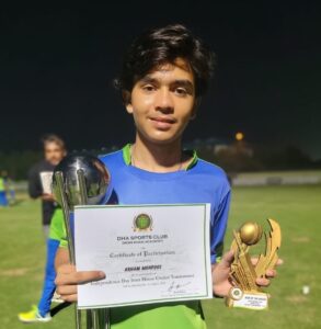 Arham Mehfooz celebrates his Man of the Match award after an all-round cricket performance in Karachi.