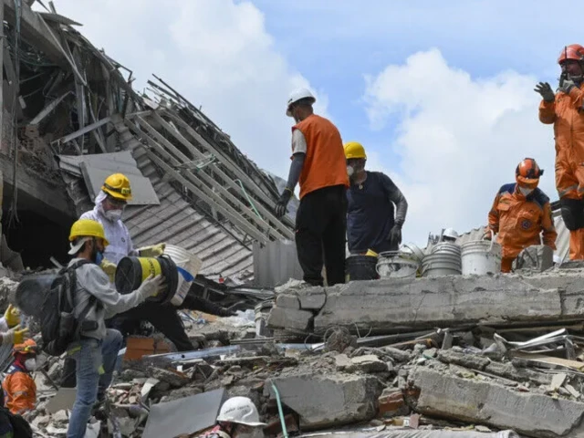 Rescue teams searching collapsed buildings after a major earthquake in Colombia
