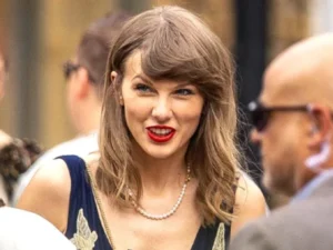 Taylor Swift with shorter blonde hair at a wedding in the UK