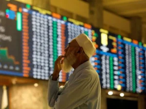 Electronic trading board at the Pakistan Stock Exchange showing a sharp rise in the KSE-100 Index.