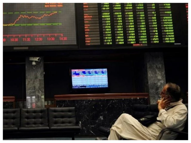 Electronic trading board displaying the KSE-100 Index at the Pakistan Stock Exchange.