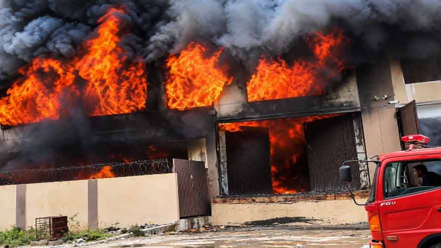 Firefighters tackle a factory fire at Landhi Export Processing Zone in Karachi