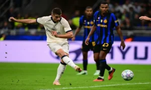 Football players competing during a Champions League match between Club Brugge and Inter Milan.