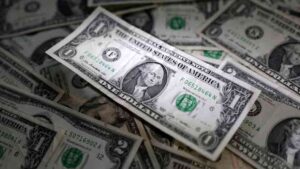 US dollar banknotes representing currency markets amid geopolitical tensions and inflation concerns.