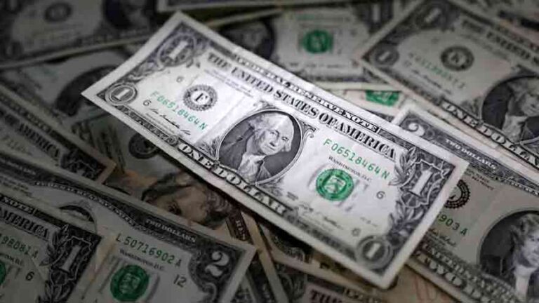 US dollar banknotes representing currency markets amid geopolitical tensions and inflation concerns.
