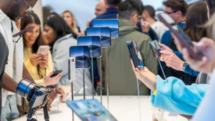 1. Apple iPhone Duo foldable smartphone displayed in a retail store.