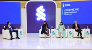 Standard Chartered Pakistan Market Outlook session in Lahore featuring investment experts discussing financial markets and portfolio diversification.